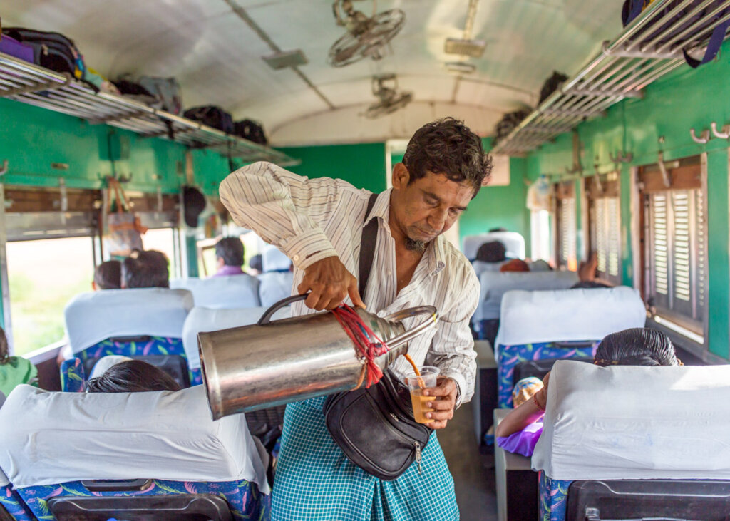 Burmese man selling tea on the Yangon train, Myanmar